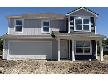 Charming two-story home featuring gray and navy siding, complemented by white trim and an attached two-car garage at 3297 Godby Dr, Sheridan, IN 46069
