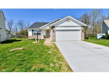 Charming single-story home with a two-car garage and a well-manicured front lawn at 4064 Waterfield Dr, Indianapolis, IN 46235