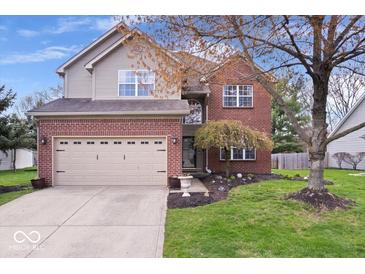 Charming two-story home features brick and siding, a two-car garage, and a well-maintained front lawn at 5343 Ripplingbrook Way, Carmel, IN 46033