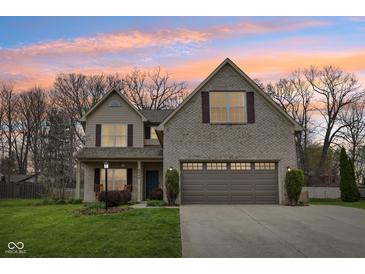 Charming two-story home with brick and vinyl siding and a well-manicured lawn at 6526 Angel Falls Dr, Noblesville, IN 46062