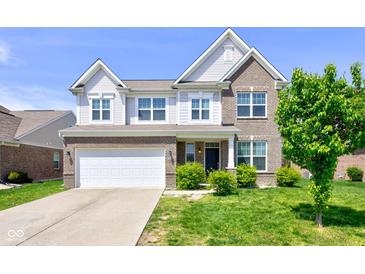 Charming two-story home featuring brick and siding, attached garage, and well-maintained landscaping at 10602 Pintail Ln, Indianapolis, IN 46239