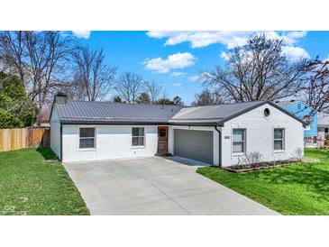 Charming single-story home with a white brick exterior, a gray roof, and a well-manicured lawn at 1280 Casco Bay Cir, Cicero, IN 46034