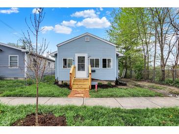 Charming single-Gathering home featuring a new wood porch and light-blue siding, landscaped yard, and sidewalk at 1719 Dawson St, Indianapolis, IN 46203