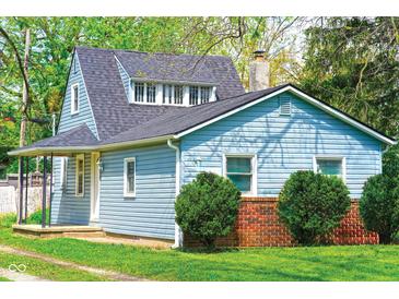 Charming single-Gathering home featuring blue siding, brick accents, and a well-maintained front yard at 2109 N Janney Ave, Muncie, IN 47304