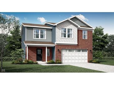 Charming two-story home featuring a brick facade, siding, a two-car garage, and a well-manicured lawn at 2209 Boxwood Dr, Greenfield, IN 46140