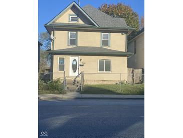 Charming two-story home featuring a fenced yard and traditional architectural details at 3241 N Capitol Ave, Indianapolis, IN 46208