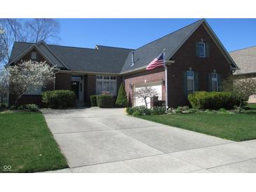Charming brick home featuring a well-manicured lawn and a spacious driveway leading to the garage at 3504 Inverness Blvd, Carmel, IN 46032