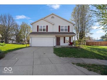 Charming two-story home features a well-maintained lawn and a two-car garage at 4613 Walker St, Greenwood, IN 46143