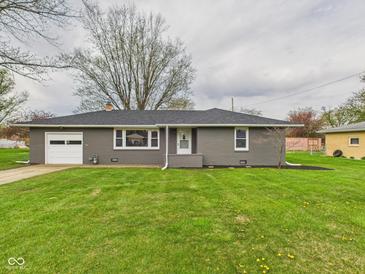 Charming single-story home featuring an attached garage and a well-maintained front yard with mature trees at 4715 Southern Ave, Anderson, IN 46013