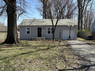 Charming single-story home featuring a well-maintained lawn, inviting entrance, and driveway with basketball hoop at 4823 Atwell Dr, Lawrence, IN 46226