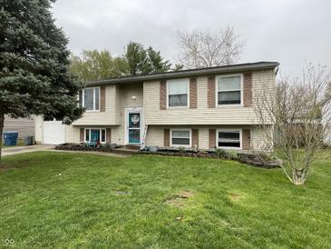 Charming two-story home featuring a well-manicured lawn, traditional siding, and inviting front door at 6225 Roberts Creek Ln, Indianapolis, IN 46221