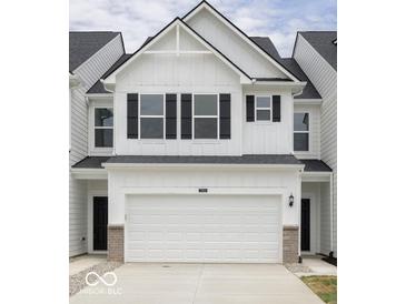 Charming two-story townhouse with a white facade, black shutters, and a spacious two-car garage at 7342 Shroyer Way, Noblesville, IN 46062