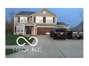 Charming two-story home with a well-maintained lawn, a two-car garage, and mature trees enhancing curb appeal at 804 Seabreeze Dr, Avon, IN 46123