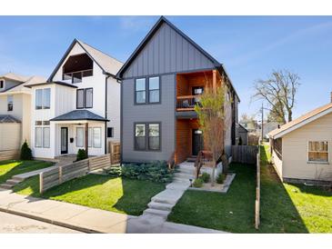 Attractive home with charcoal gray siding, natural wood accents and a small front yard at 807 E Minnesota St, Indianapolis, IN 46203