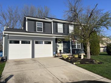 Charming two-story home with a well-maintained lawn and a two car garage at 12458 Trumbull Ct, Fishers, IN 46038