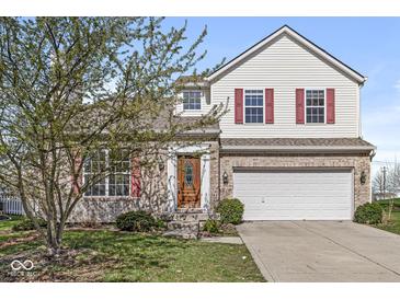 Charming two-story home with a brick facade, red shutters, and a well-maintained front lawn, offering great curb appeal at 14538 Baldwin Ln, Carmel, IN 46032