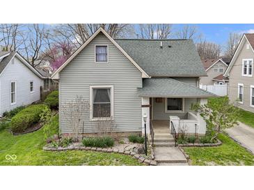 Charming home with gray siding, green roof, landscaped yard, and a welcoming front porch at 304 W 4Th St, Greenfield, IN 46140