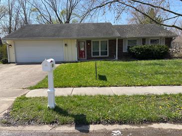 Charming one-story home with a well-manicured lawn and a two-car garage, perfect for suburban living at 3102 Pawnee Dr, Indianapolis, IN 46235