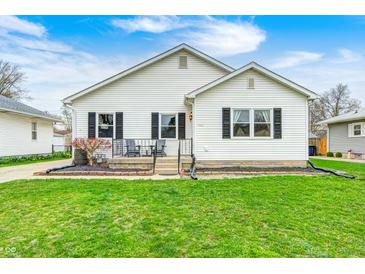 Charming home featuring a well-maintained lawn and a welcoming front porch with seating at 438 N 11Th Ave, Beech Grove, IN 46107