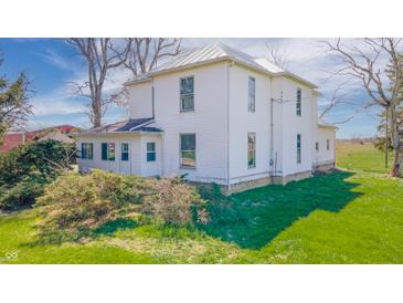 Charming two-story home with mature landscaping and a well-maintained lawn at 10723 E State Road 234, Wilkinson, IN 46186
