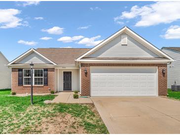 Charming single-story home with brick accents, a two-car garage, and well-maintained lawn under a bright sky at 10844 Tedder Lake Dr, Indianapolis, IN 46239