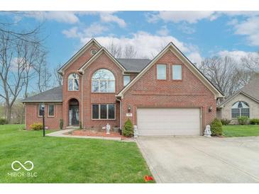 Charming two-story brick home with well-manicured lawn and attached two-car garage at 130 George Ct, Danville, IN 46122