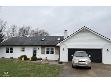 Charming brick ranch with attached garage, mature trees, and well-maintained landscaping at 13440 E 166Th St, Noblesville, IN 46060