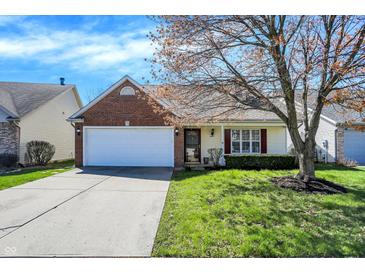 Charming single Gathering home featuring an attached garage and a well-maintained lawn at 14917 Mia Dr, Carmel, IN 46033