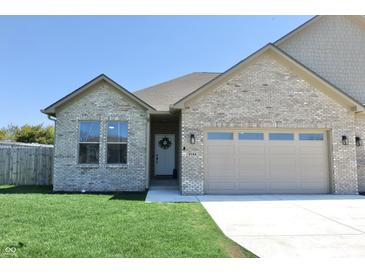 Charming single-story brick home with a well-manicured lawn and a two-car garage at 2144 Connie Ct, Franklin, IN 46131