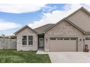 Charming brick home featuring a two-car garage, manicured lawn, and inviting entrance at 2144 Connie Ct, Franklin, IN 46131