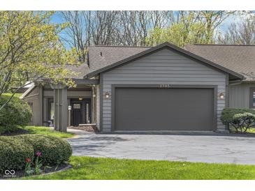 Charming home featuring a two-car garage, manicured lawn, and welcoming entryway at 2305 Van Ness Pl, Indianapolis, IN 46240
