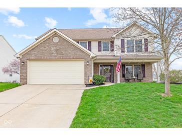 Charming two-story home with brick accents, attached garage, and well-manicured front lawn at 3130 Shadow Lake Dr, Indianapolis, IN 46217