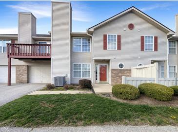 Charming two-story home with red shutters, attached garage, and small front yard at 4630 Kelvington Dr, Indianapolis, IN 46254