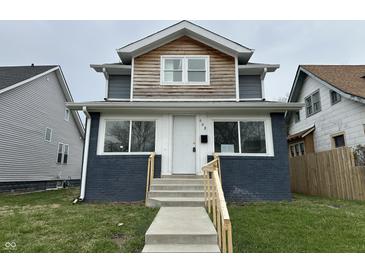 Charming home featuring a brick front, a mix of wood and gray siding, and a newly built front porch at 608 N Gray St, Indianapolis, IN 46201
