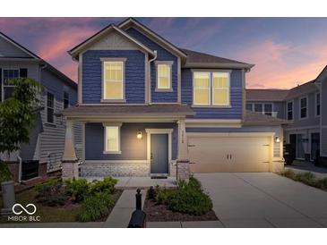Charming two-story home with blue siding, a covered porch, and a well-manicured lawn at 7012 Pickett Pl, Carmel, IN 46033