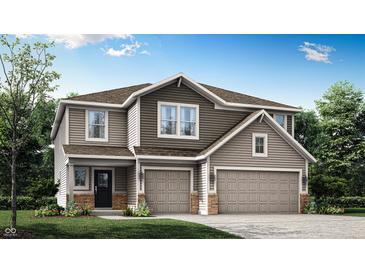 Inviting two-story home features an attached two-car garage, neutral siding, and a well-manicured lawn at 7242 Estes Dr, Indianapolis, IN 46239