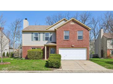 Charming two-story home with a combination of red brick and gray siding at 7418 Bluebird Ct, Indianapolis, IN 46254