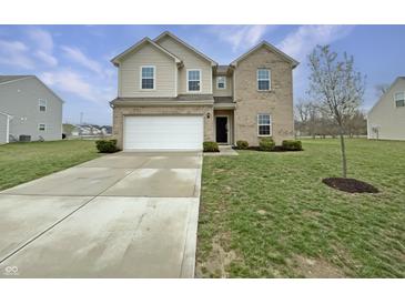 Charming two-story home with a two-car garage, brick and siding exterior, and well-manicured lawn at 771 Carolina Way, Avon, IN 46123