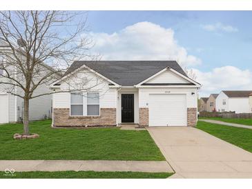 Well-maintained single-story home featuring a one-car garage, brick accents, and a neatly manicured front lawn at 8529 Sansa St, Camby, IN 46113