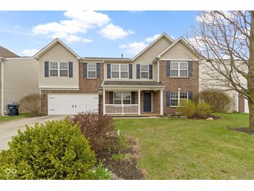 Charming two-story home with brick and vinyl siding, manicured lawn, and inviting front porch at 10955 Balfour Dr, Noblesville, IN 46060