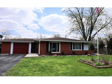 Charming single-story brick home with an attached garage and a well-maintained front lawn at 1255 Easy St, Greenwood, IN 46142