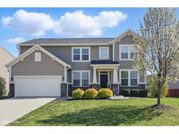 Charming two-story home with a well-maintained lawn and landscaping, showcasing curb appeal at 1575 Oakvista Dr, Greenwood, IN 46143