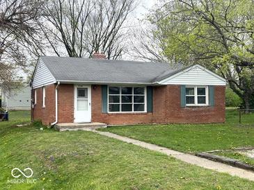 Charming brick home with green shutters, a well-manicured lawn, and a welcoming walkway at 2120 Sheffield Ave, Anderson, IN 46011