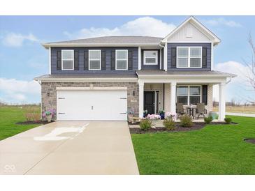 Charming two-story home with blue siding, stone accents, and a well-manicured lawn at 2538 Redding Dr, Whitestown, IN 46075