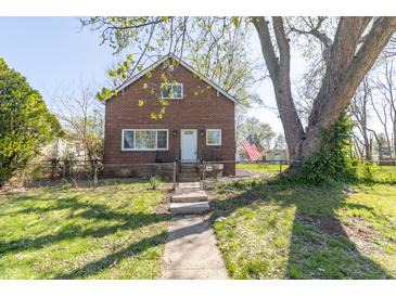 Charming brick home with landscaped front yard and a walkway leading to the front door at 2741 Mars Hill St, Indianapolis, IN 46241