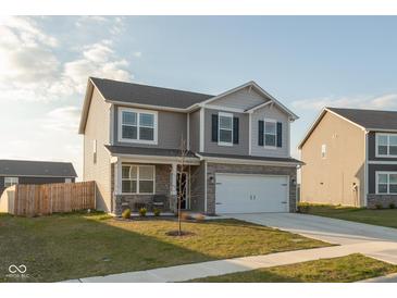 Charming two-story home featuring gray siding, a two-car garage, and a well-manicured front lawn at 2960 W Patchwork Dr, Monrovia, IN 46157