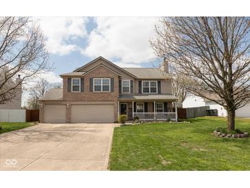 Charming two-story home with a well-manicured lawn and a welcoming front porch at 464 Hummingbird Ln, Whiteland, IN 46184