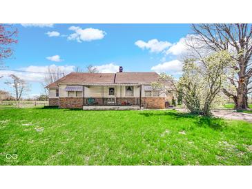 Charming single-story home with stone accents, a front porch, and a well-maintained lawn at 5196 N London Rd, Fairland, IN 46126