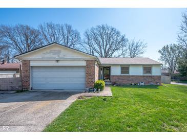 Charming single-story home featuring a brick facade, attached garage, and a well-maintained front yard at 617 Kokomo Ln, Indianapolis, IN 46241