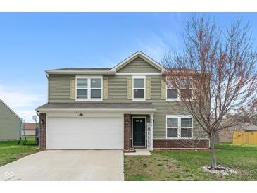 Charming two-story home featuring an attached two-car garage and manicured lawn at 6316 Avacado Dr, Indianapolis, IN 46217